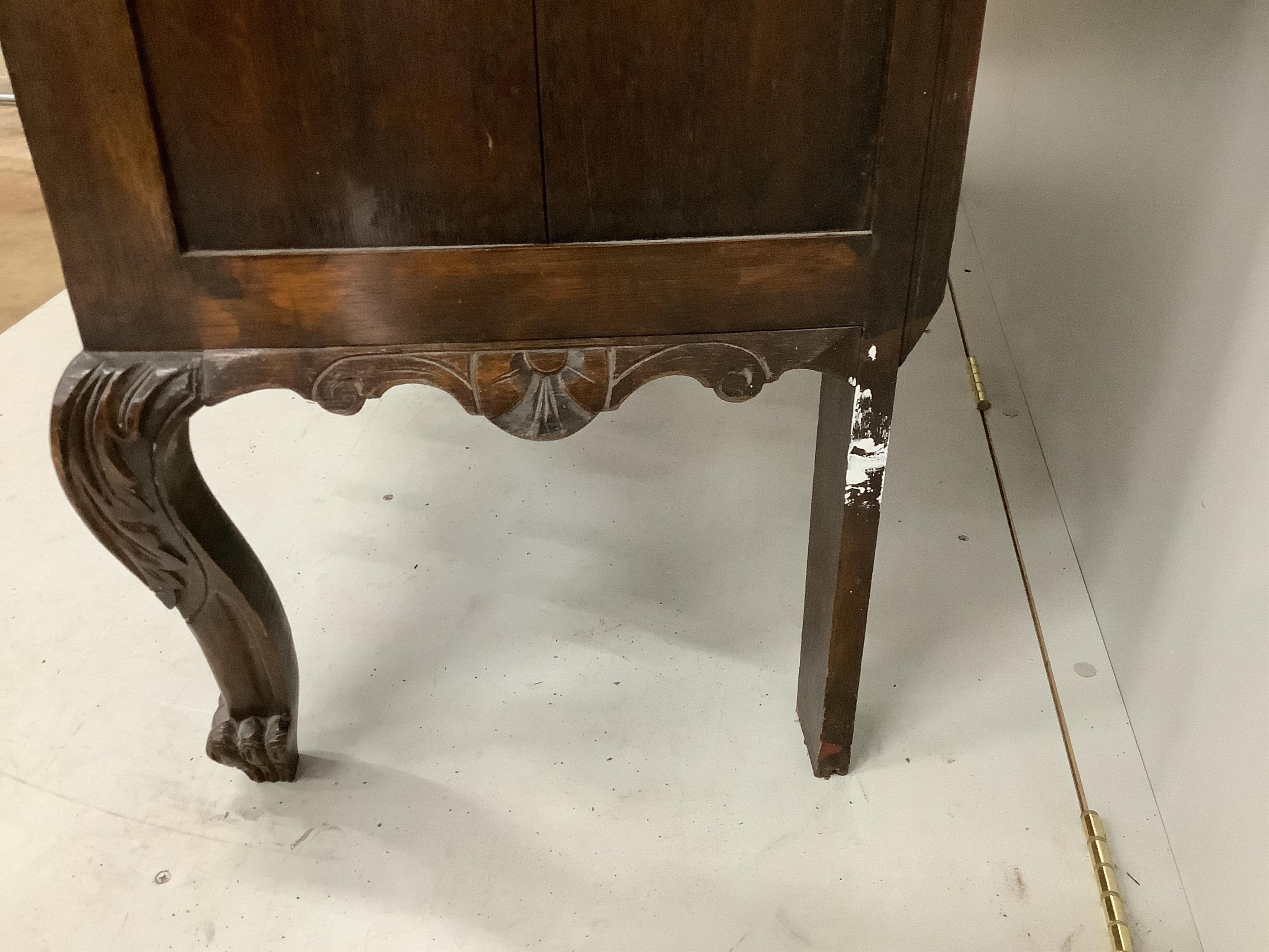 An early 20th century Flemish carved oak bow front dresser, width 138cm, depth 50cm, height 185cm